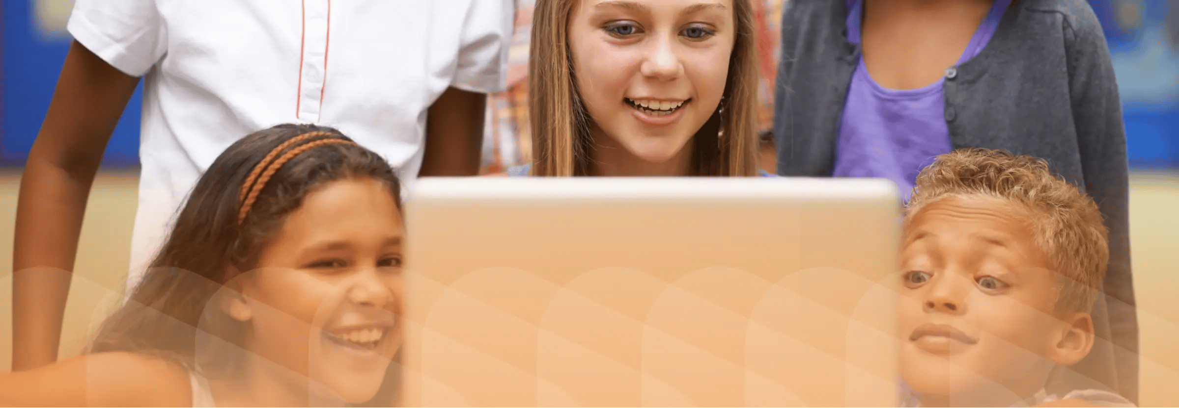 Students participating in digital storytelling activity on laptop. Orange filter on top of image.